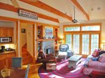 Schoolhouse Cottage - Living Area with Fireplace, Comfortable Furnishings and Sliding doors out to the deck